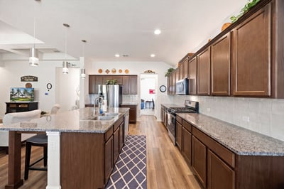 This spacious kitchen features ample cabinetry, modern appliances, and an inviting layout perfect for gatherings.