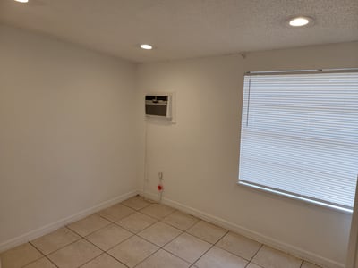 Bright, airy space featuring tile flooring and natural light, perfect for a cozy office or study.