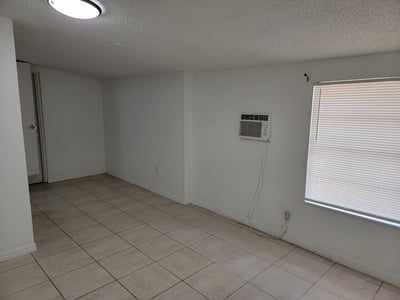 Spacious room with tile flooring and ample natural light, perfect for creating your ideal living space.
