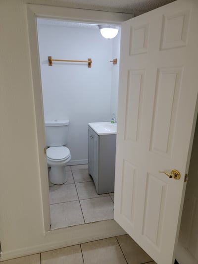 Bright bathroom featuring modern fixtures and ample space, conveniently accessible from the main living area.