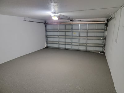 Spacious garage with a smooth floor, ideal for vehicles or additional storage solutions.