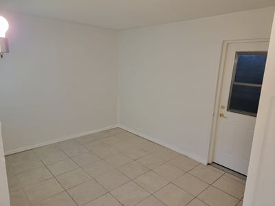 Spacious, versatile room with natural light and easy access to an outdoor entryway. Perfect for customization.