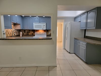 Bright kitchen featuring modern appliances and ample counter space, perfect for culinary enthusiasts.