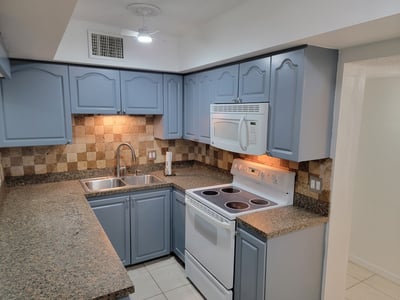 Modern kitchen featuring updated appliances, ample counter space, and a functional layout for cooking enthusiasts.