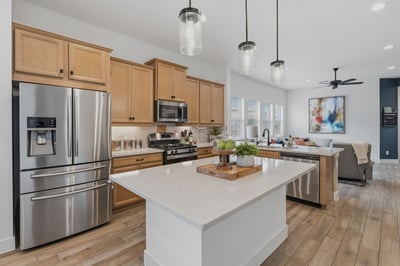 Kitchen island, pendant lights, and a breakfast bar on the other side of the sink. Chef's kiss!