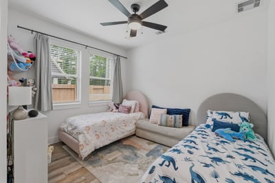 French doors lead into this home office space that is currently being used as a 5th bedroom for little ones.