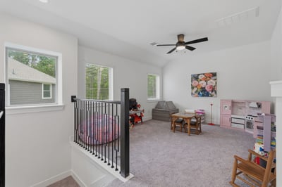 At the top of the stairs is a large game room perfect for a play space or extra TV room for the family.