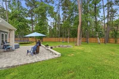 The backyard is massive! Fire pit, mature trees, and plenty of space to play.