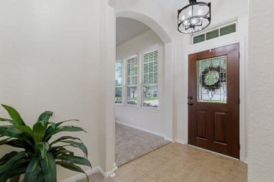 Entry way with updated lighting and gorgeous refinished front door.