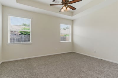 Fantastic primary bedroom with tray ceilings.