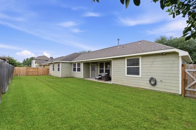 Newer fence and well-maintained grass.
