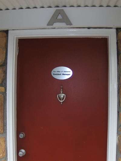 Inviting entrance featuring a bold red door and unique stone accents, ideal for your next home.