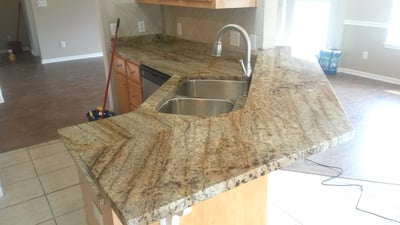 Modern kitchen featuring a spacious granite countertop, ideal for cooking and entertaining in an open layout.