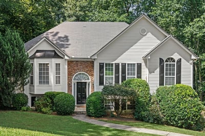 Discover this inviting two-story home, featuring a welcoming entrance and a beautifully landscaped front yard.