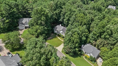 Nestled among mature trees, this inviting home offers a private retreat with spacious outdoor areas.