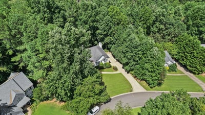 Nestled among lush foliage, this home offers privacy while remaining conveniently close to community amenities.