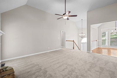 Spacious living area with high ceilings, neutral tones, and ample natural light, perfect for customization.