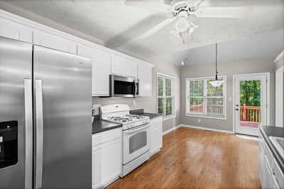 Bright kitchen featuring modern appliances, ample natural light, and easy access to outdoor space.