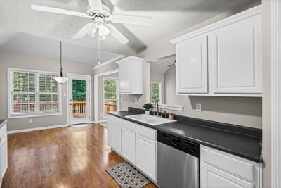 Bright kitchen featuring modern appliances, ample cabinetry, and natural light flowing through spacious windows.