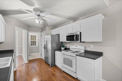 Bright kitchen featuring modern appliances, ample cabinetry, and an inviting layout perfect for gatherings.