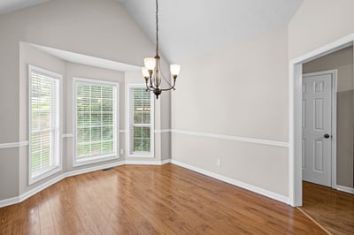 Bright and spacious dining area features large windows and a unique architectural design, perfect for entertaining.