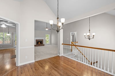 Spacious two-story foyer with natural light and open views, leading to inviting living areas and cozy fireplace.