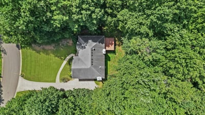 Discover this private retreat nestled among lush trees, featuring a spacious yard and easy access to nearby roads.