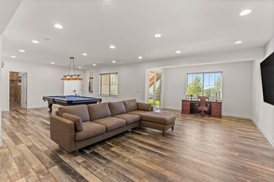 Spacious open-concept living area featuring a billiards table and a large window with stunning views.