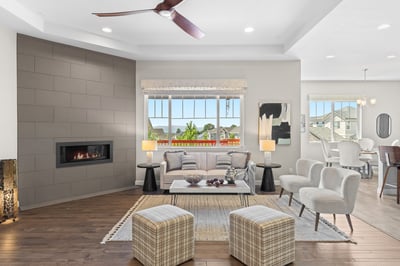 Modern open-concept living space featuring a cozy fireplace and panoramic views of the surrounding landscape.