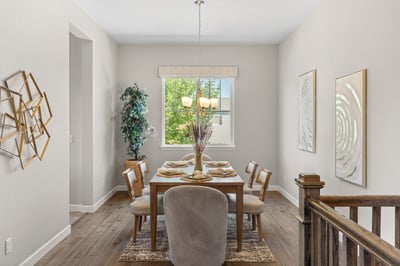 Bright dining area featuring large windows, modern décor, and ample space for gatherings and entertaining.