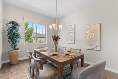 Bright dining area featuring modern decor, large windows, and a spacious layout perfect for gatherings.