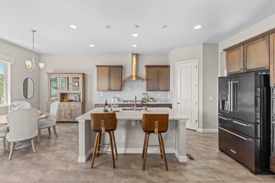 Bright and functional kitchen featuring an island, modern appliances, and ample dining space for family gatherings.