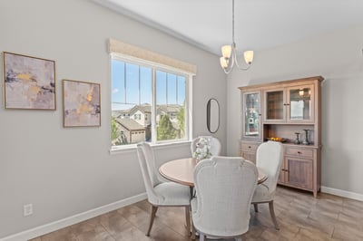 Bright dining area featuring large windows, offering scenic views and ample natural light for gatherings.