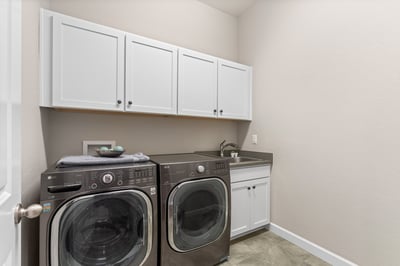 Bright and functional laundry room featuring modern appliances and ample storage for convenience and organization.