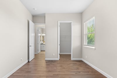 Bright and airy room featuring hardwood floors, natural light, and a spacious closet, perfect for personalization.
