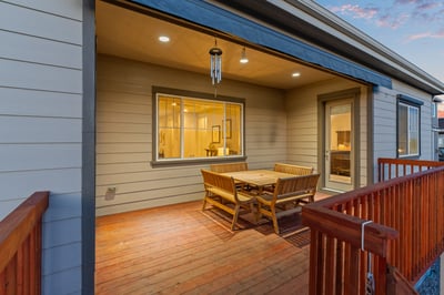 Spacious covered patio features ample seating, perfect for outdoor gatherings and enjoying neighborhood views.