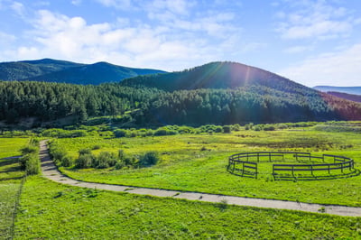 Scenic property featuring vast green pastures and stunning mountain views, ideal for your dream home or retreat.