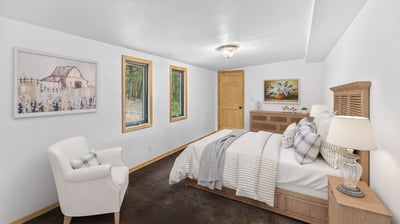 Cozy bedroom featuring warm wood accents, comfortable furnishings, and natural light from multiple windows.