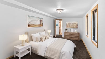 Bright and inviting bedroom features modern decor, ample natural light, and a cozy atmosphere for relaxation.