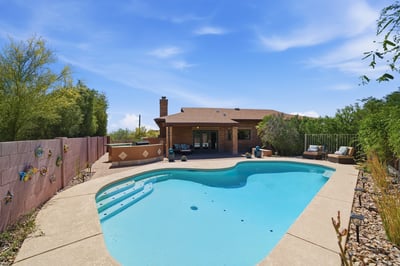 Discover a spacious backyard oasis featuring a refreshing pool, ideal for outdoor gatherings and relaxation.
