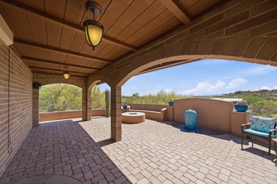 Spacious covered patio featuring unique architectural details and stunning views, perfect for outdoor gatherings or relaxation.