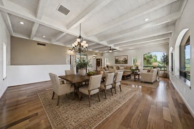 Spacious open-concept living area with abundant natural light and attractive hardwood flooring, perfect for entertaining.