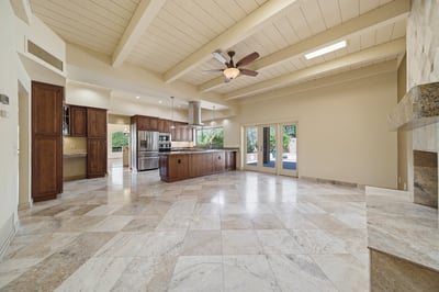 Spacious open-concept kitchen and living area feature high ceilings and abundant natural light, ideal for entertaining.