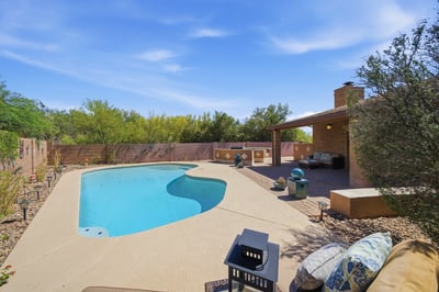 Discover this inviting backyard oasis featuring a refreshing pool and ample space for outdoor gatherings.