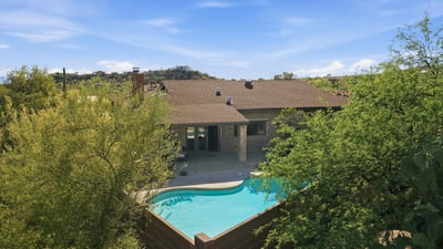 Discover this inviting home with a private pool, nestled among lush landscaping and scenic views.
