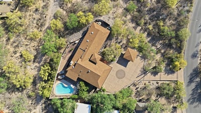 Sprawling property featuring a private pool, outdoor entertainment area, and expansive surrounding landscape for ultimate privacy.