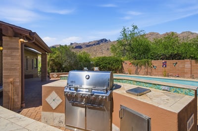 This outdoor oasis features a built-in BBQ and a refreshing pool, surrounded by stunning mountain views.