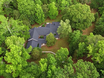 Nestled among lush greenery, this spacious home offers privacy and tranquility on a generous lot.