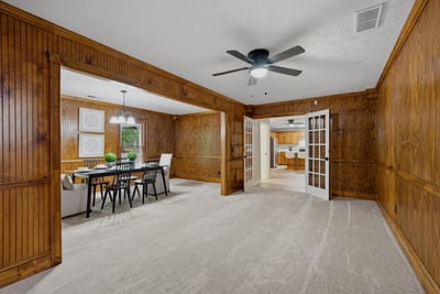 This spacious, multi-purpose area features natural wood accents and accommodates various layouts for living and dining.