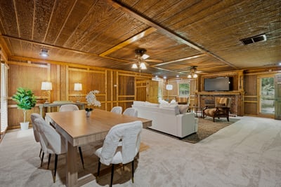 Spacious living area features natural wood accents, premium furnishings, and ample space for gatherings or relaxation.